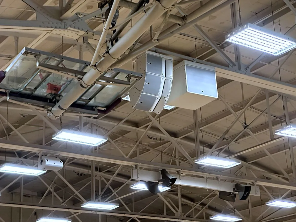 A three-box L-Acoustics A10i array and an SB18i subwoofer hung from the roof steel at Hutton Arena